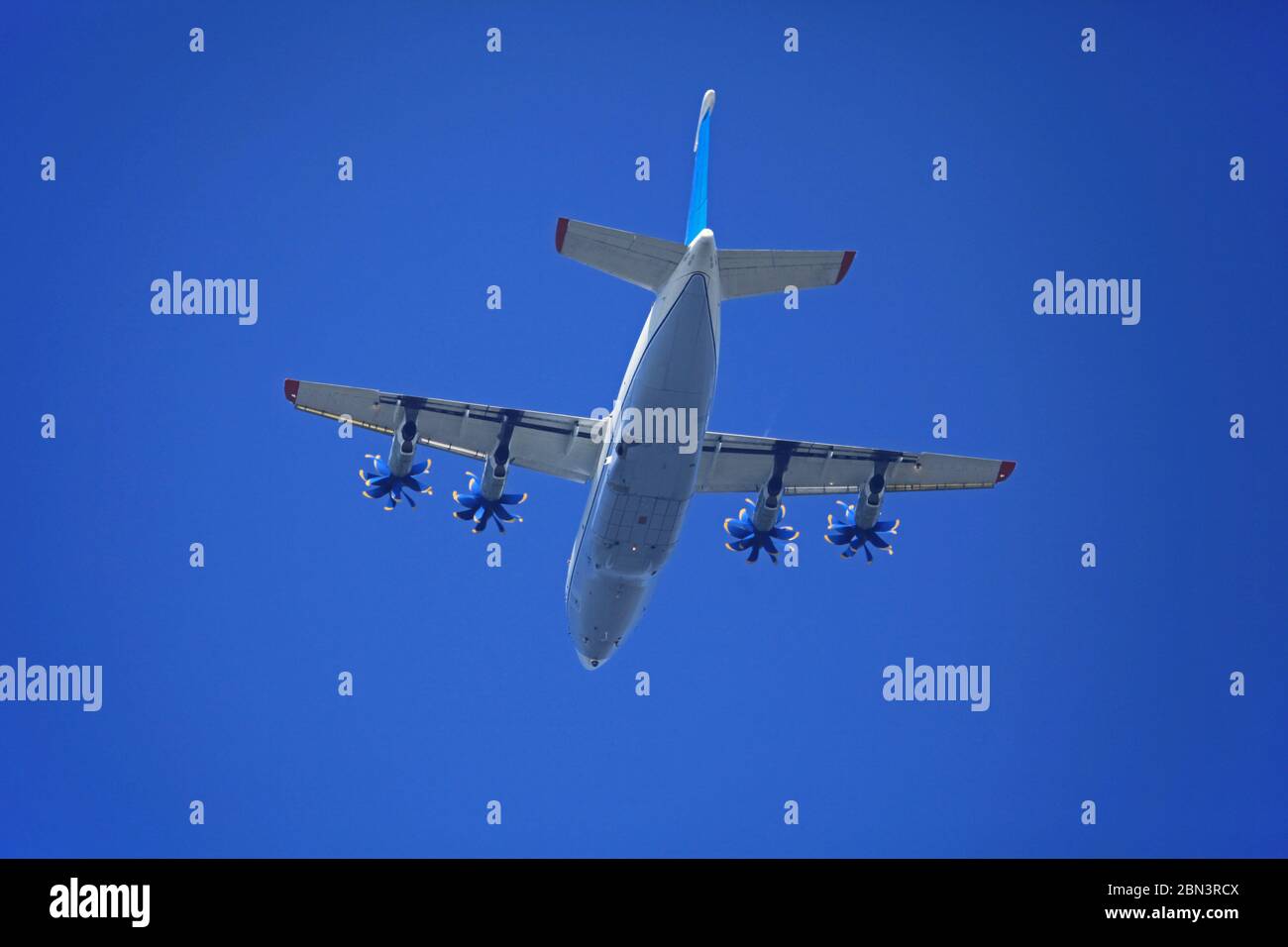 Plane (aircraft) in the blue sky. Ukrainian mid-range aircraft Antonov 70 with turbofan engines in flight Stock Photo