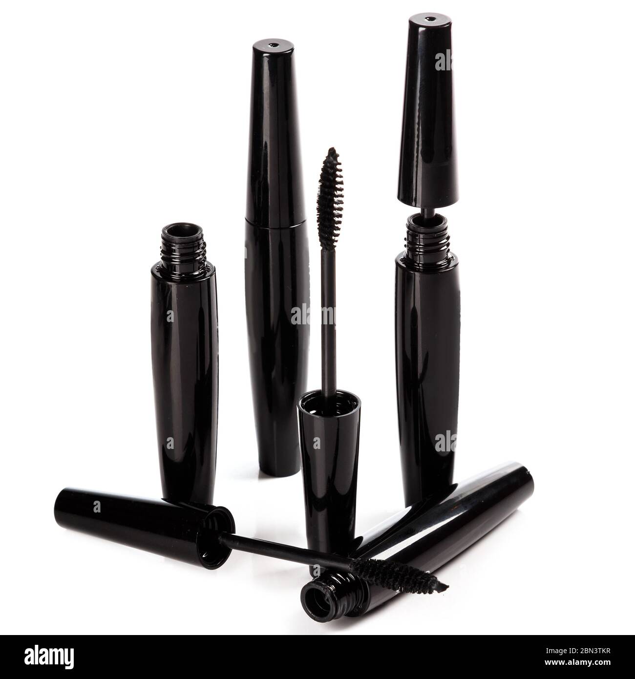 Mascara brushes and containers on white background Stock Photo