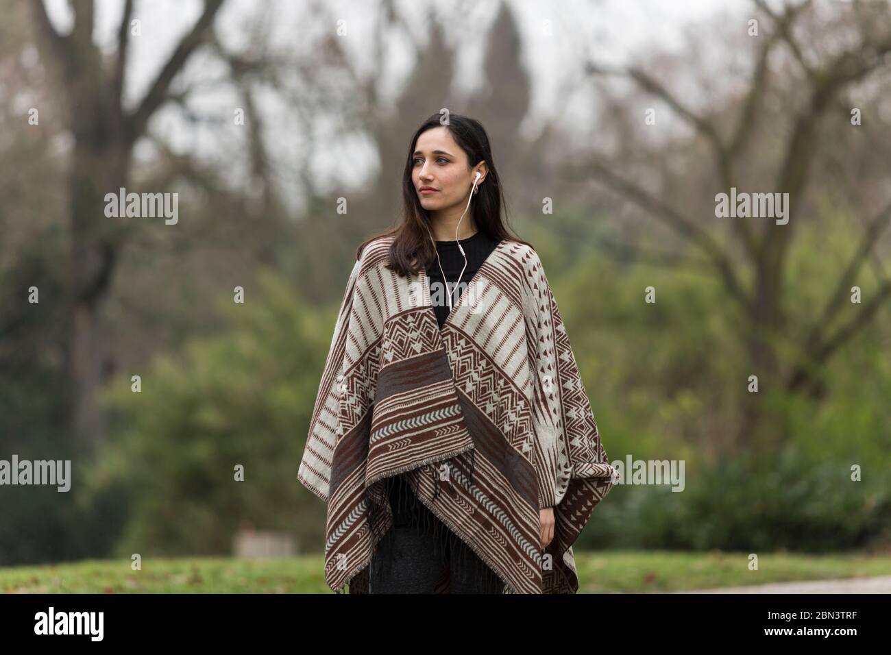 Indian woman dressed and poncho looking confidently with head Stock Photo -