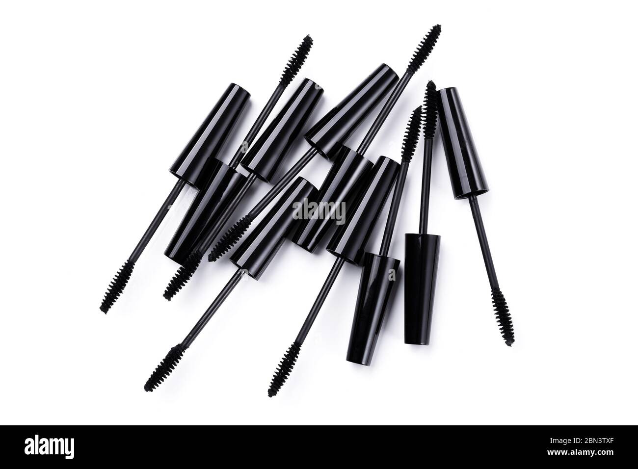 Mascara brushes and containers on white background Stock Photo