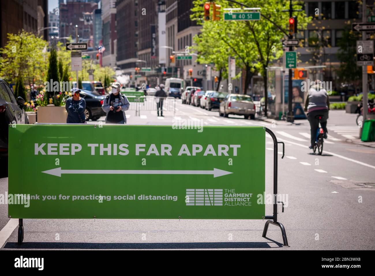 A sign reminds people of social distancing on the closed to traffic Broadway in the Garment District in New York on Thursday, May 7, 2020. To take pressure off the parks New York is closing some streets to vehicular traffic so people can take a walk while social distancing and has opened up another 1.5 miles today including this stretch of Broadway.  (© Richard B. Levine) Stock Photo