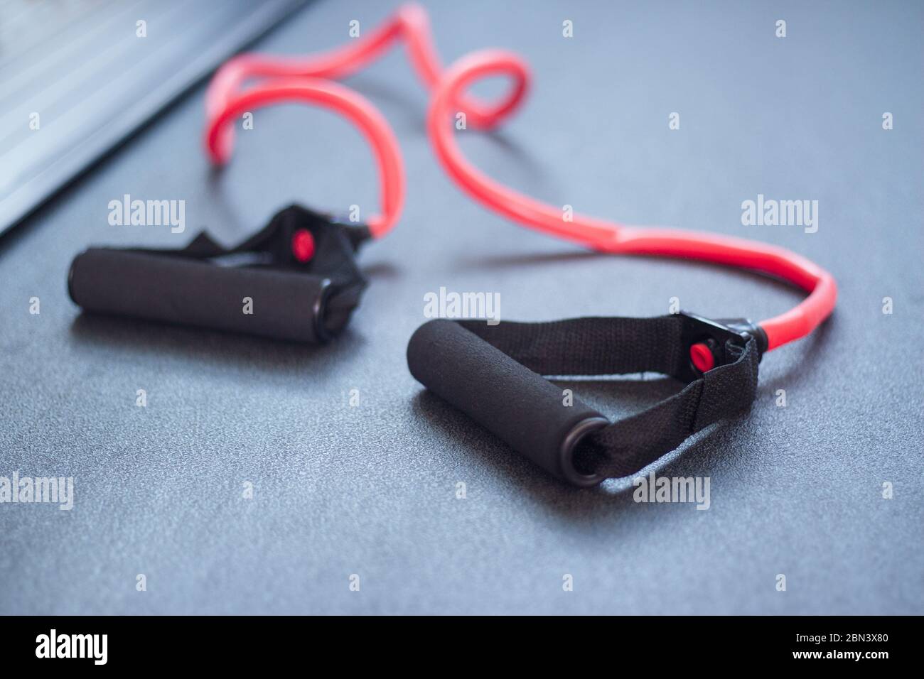 Elastic band for arm exercises on the floor. No people Stock Photo Alamy