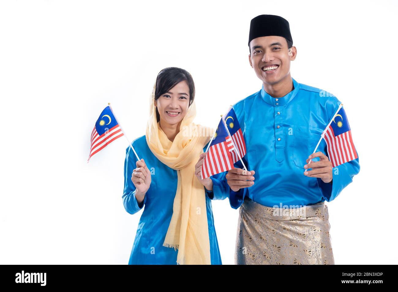 portrait of asian beautiful muslim couple with malay flag Stock Photo