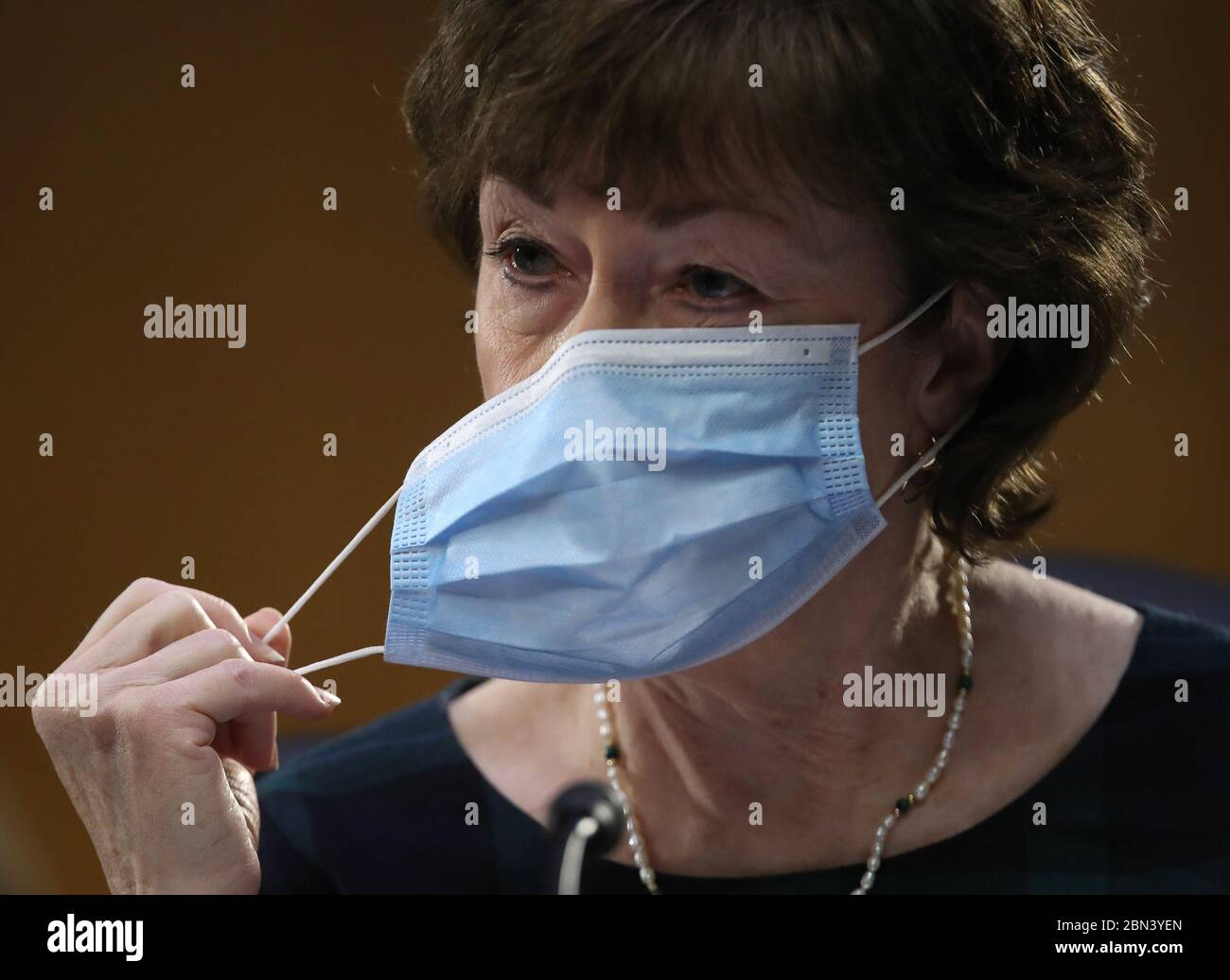 Washington, United States. 12th May, 2020. Sen. Susan Collins (R-ME) takes off her mask before speaking during in a Senate Health, Education, Labor and Pensions Committee hearing on Capitol Hill on Tuesday, May 12, 2020 in Washington, DC. The committee is hearing testimony from members of the White House Coronavirus Task Force on how to safely reopen the country. Chairman Lamar Alexander and the witnesses are all in self-quarantine since they have been exposed to the virus. Pool Photo by Win McNamee/UPI Credit: UPI/Alamy Live News Stock Photo