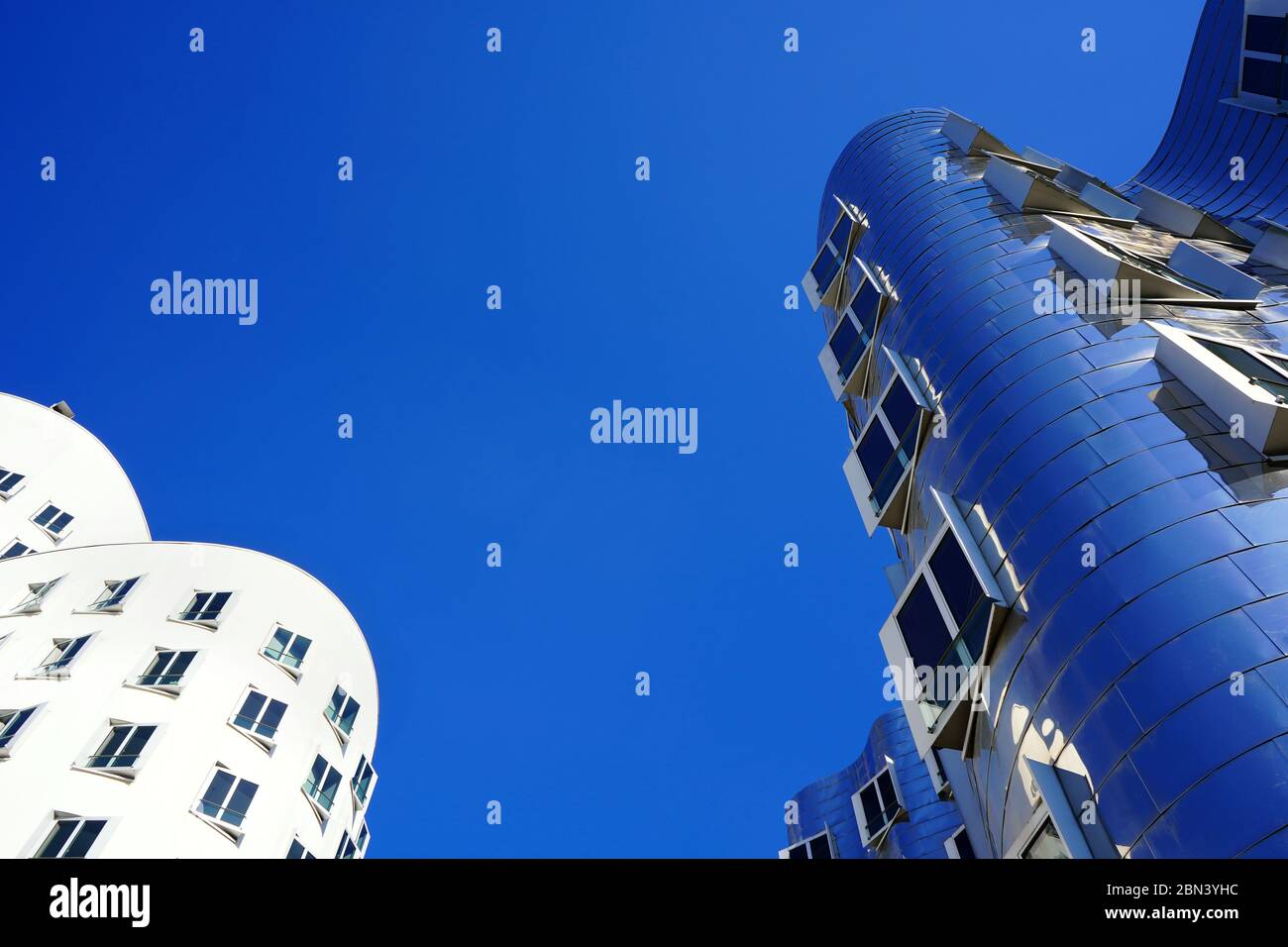Worm's eye view of two buildings designed by the American star architect Frank O. Gehry at 'Neuer Zollhof' in the Media Harbour (Medienhafen) district. Stock Photo