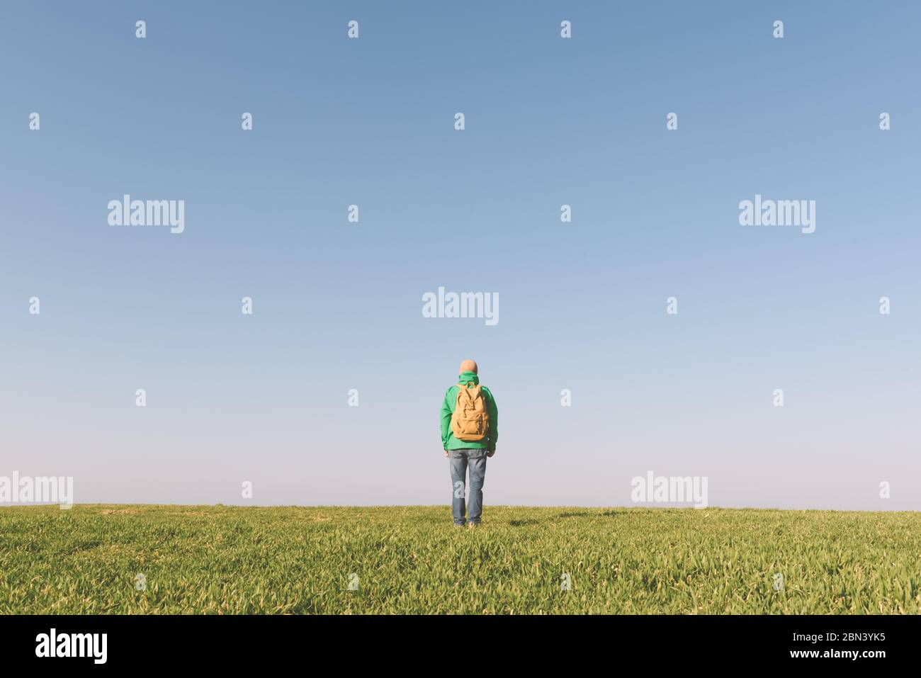 Tourist with backpack alone on summer field. Travel concept Stock Photo