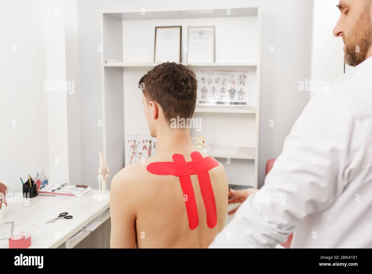 Kinesiology taping. Physical therapist applying kinesiology tape to