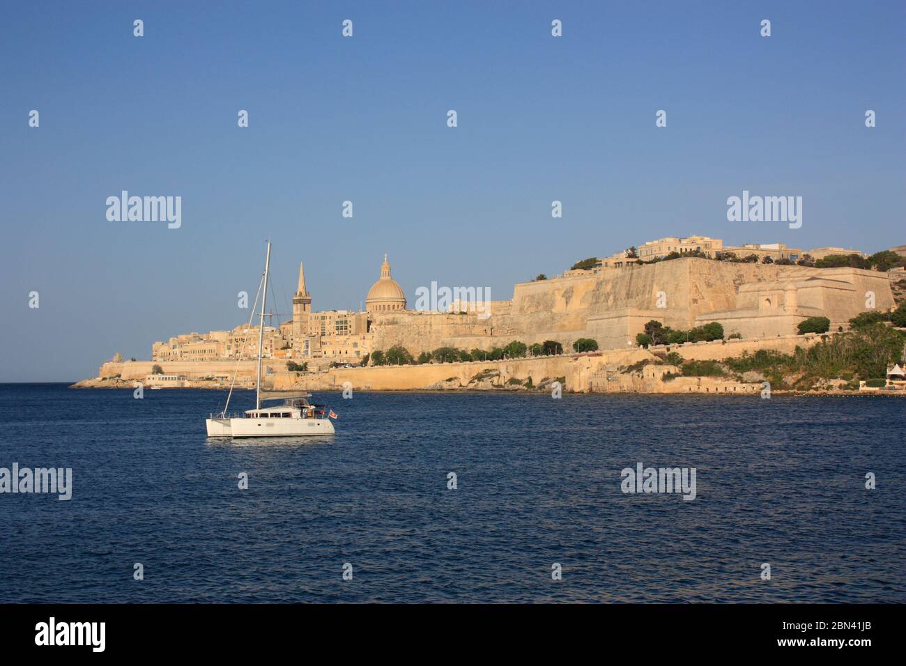 Valletta, Malta, a historic European fortified city. Landscape view from Marsamxett during golden hour. Travel and tourism in the Mediterranean Sea. Stock Photo