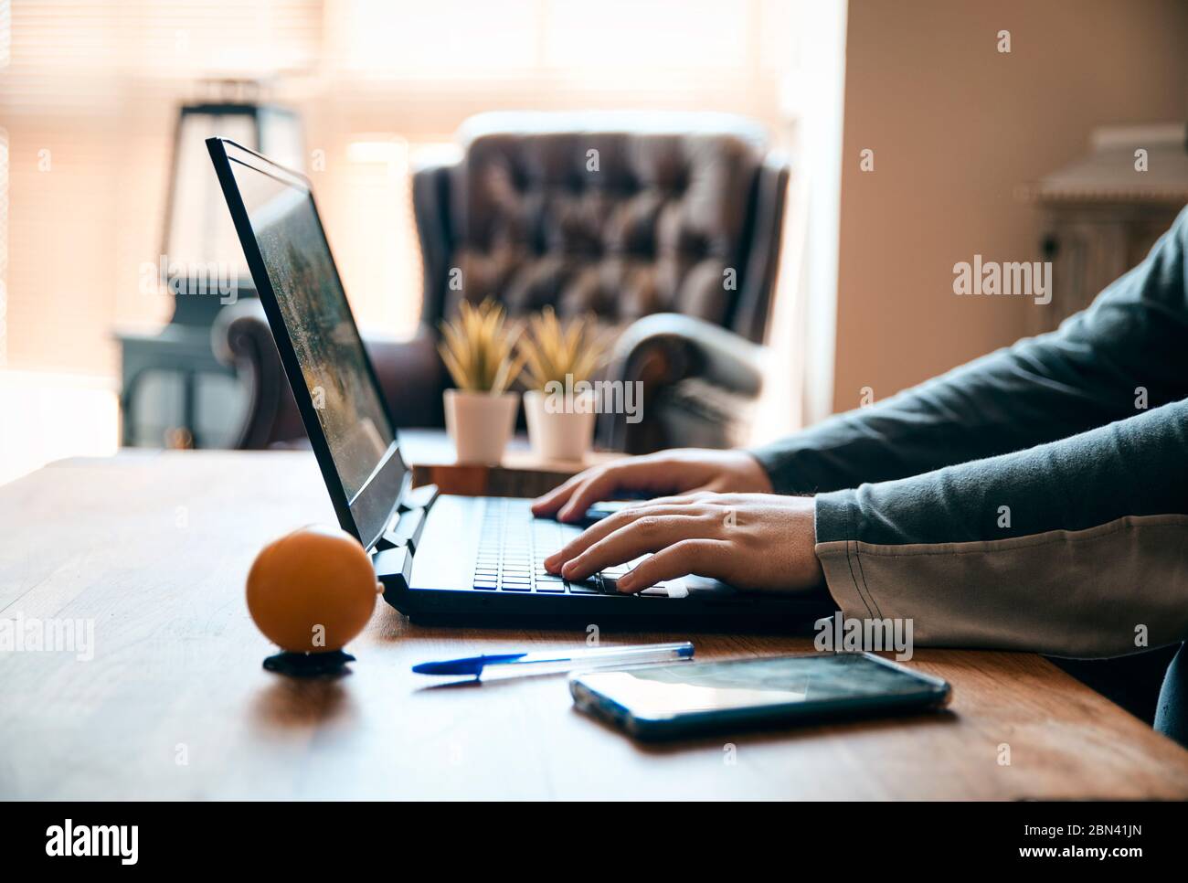 Working at home with a laptop, hands Stock Photo - Alamy