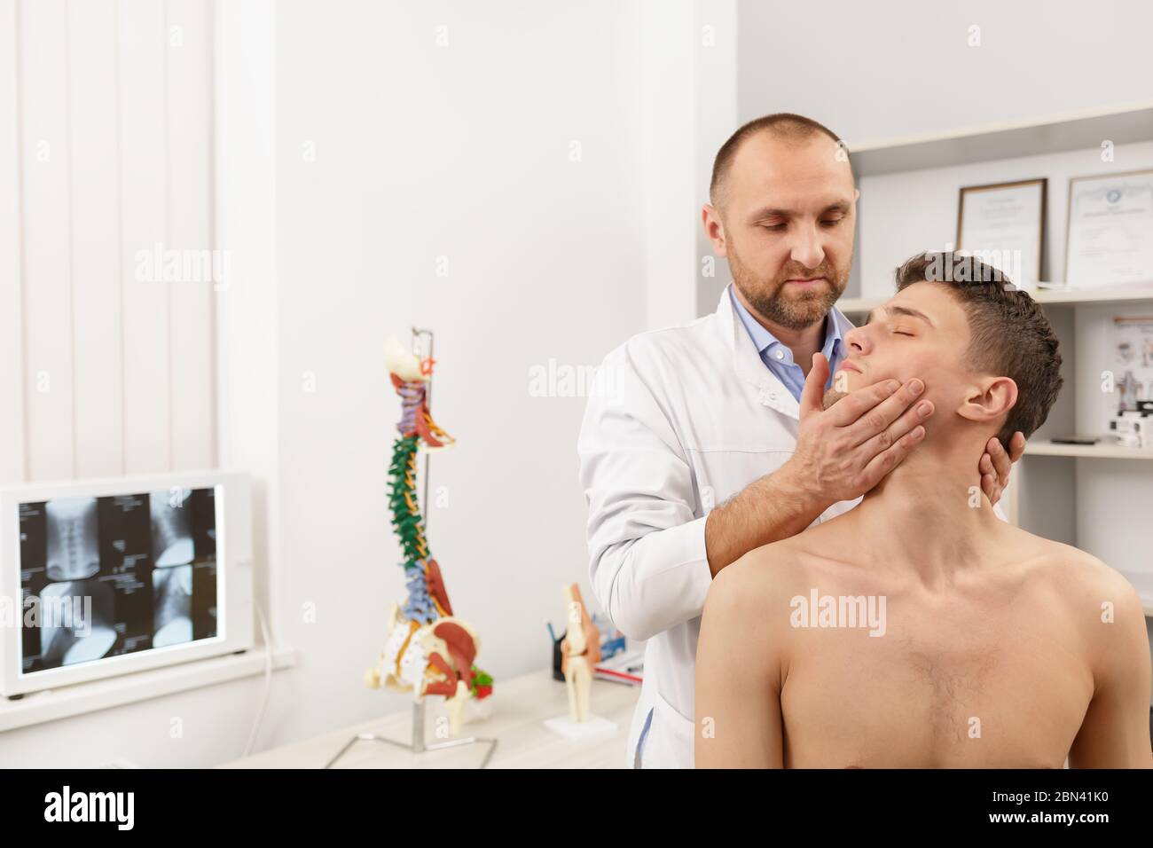 Manual therapist doing manual adjustment on patient s spine. Chiropractic, osteopathy, manual therapy, post traumatic rehabilitation, sport physical Stock Photo