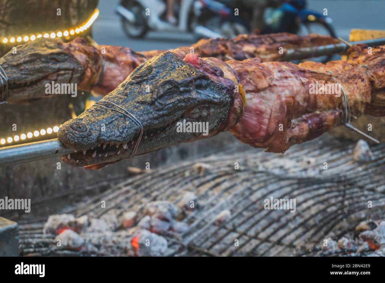 Grilled crocodile on the open fire at sea food restaurant, exotic meals in Viethnam, food of the