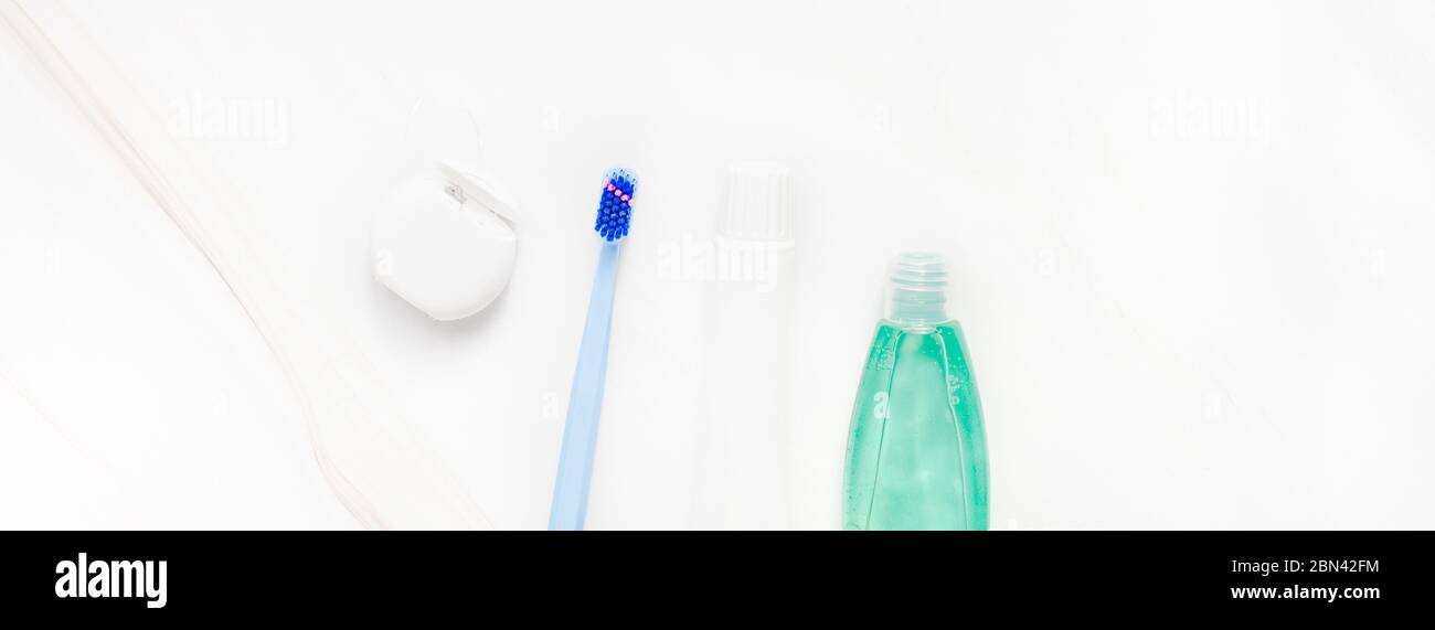 Teeth hygiene and oral dental care products on white marble table ...