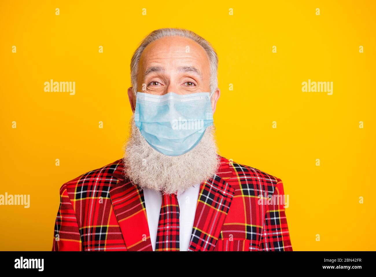 Closeup photo of amazing cool look grandpa guy stylish beard theme party wear tartan costume outfit with protection medical facial mask isolated Stock Photo