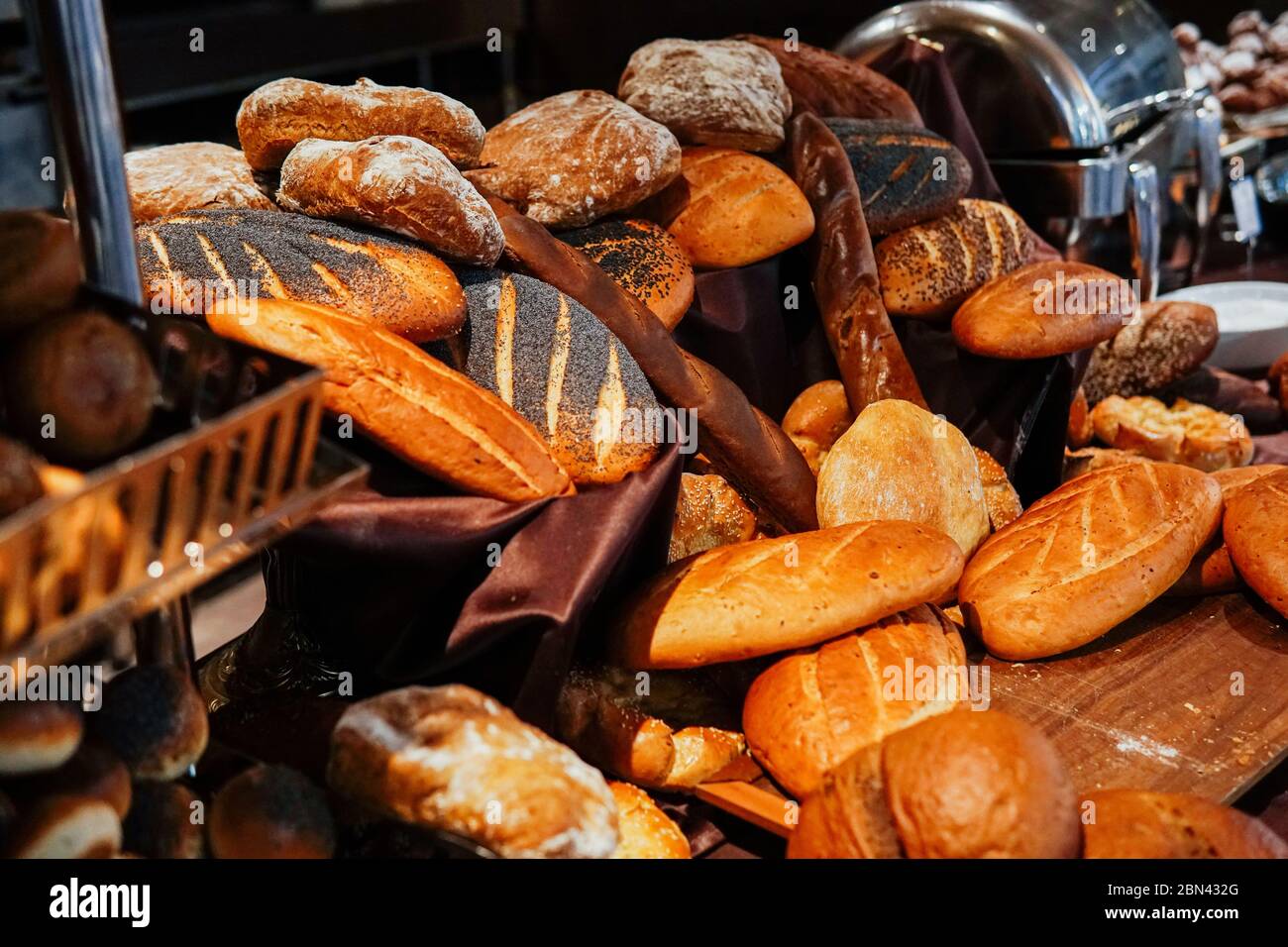 many rolls of different breads in the bakery restaurant Stock Photo