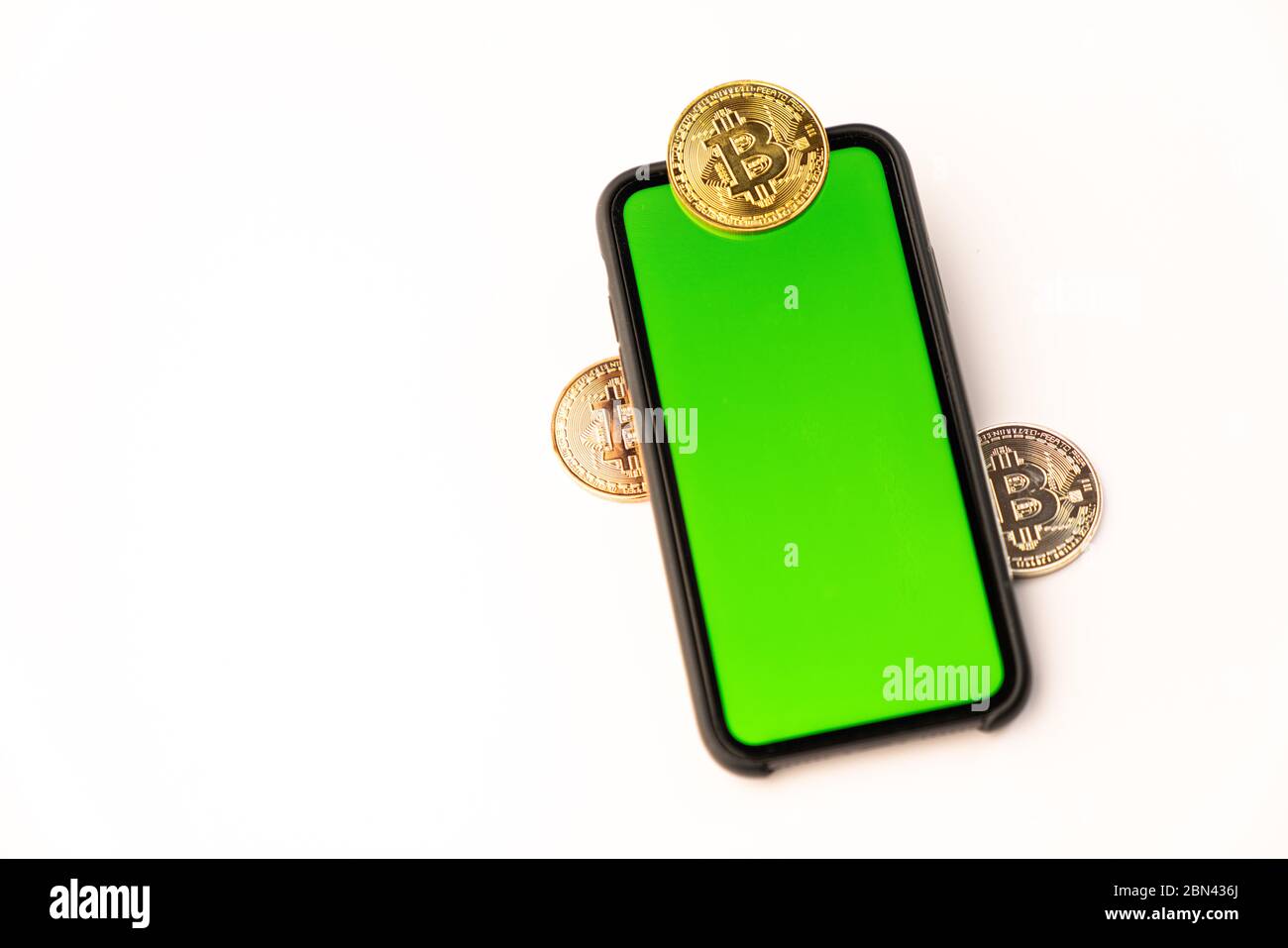 Bitcoin golden coins on handphone with green screen isolated on white ...
