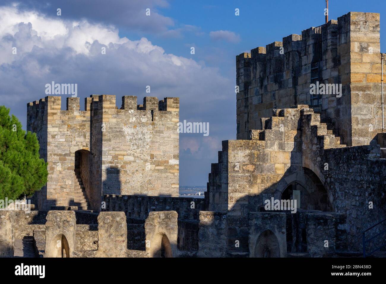 The afternoon sun lights up the ramparts of the Castle of São Jorge, atop a hill in Lisbon, Portugal. Stock Photo