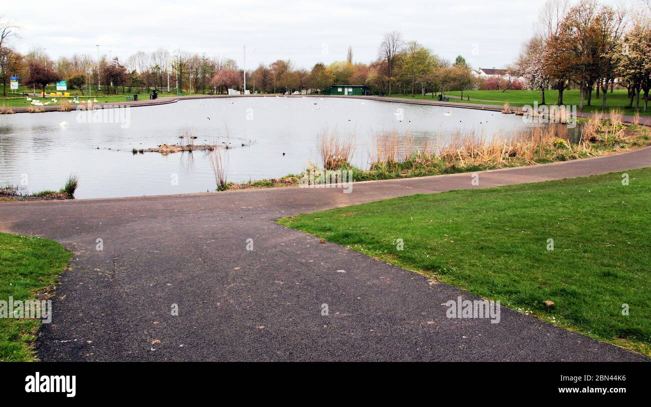 The pond, and surrounding park, in Knightswood, Glasgow, are empty and deserted because of the Covid-19 coronavirus pandemic that is raging through Britain and has put the country into lockdown and operate a stay at home policy. May 2020. ALAN WYLIE/ALAMY© Stock Photo