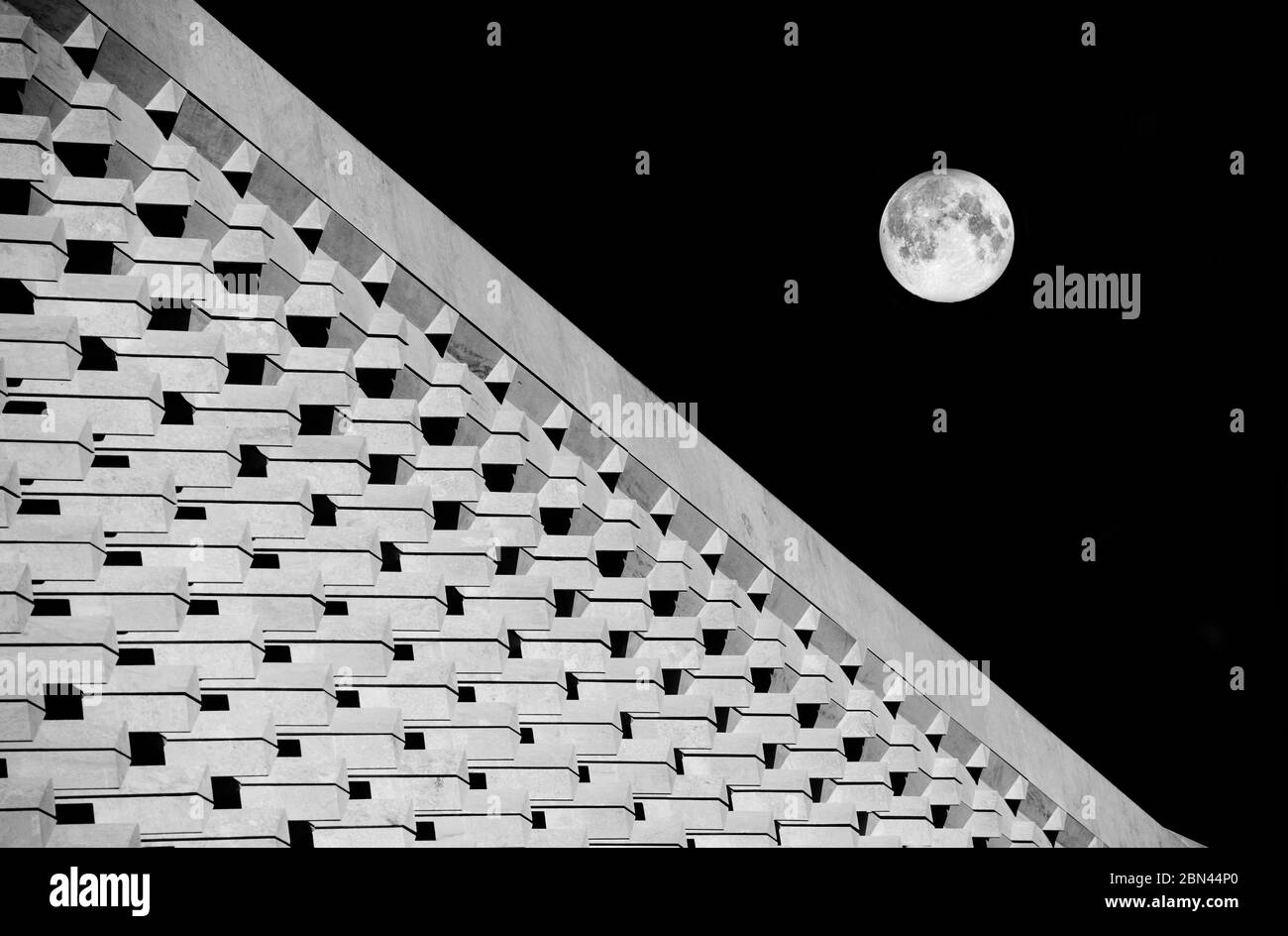 Architecture abstract photo with full moon in dark background.Fragment photo of Valletta New Parliament, Malta. Modern architecture fragment and full Stock Photo