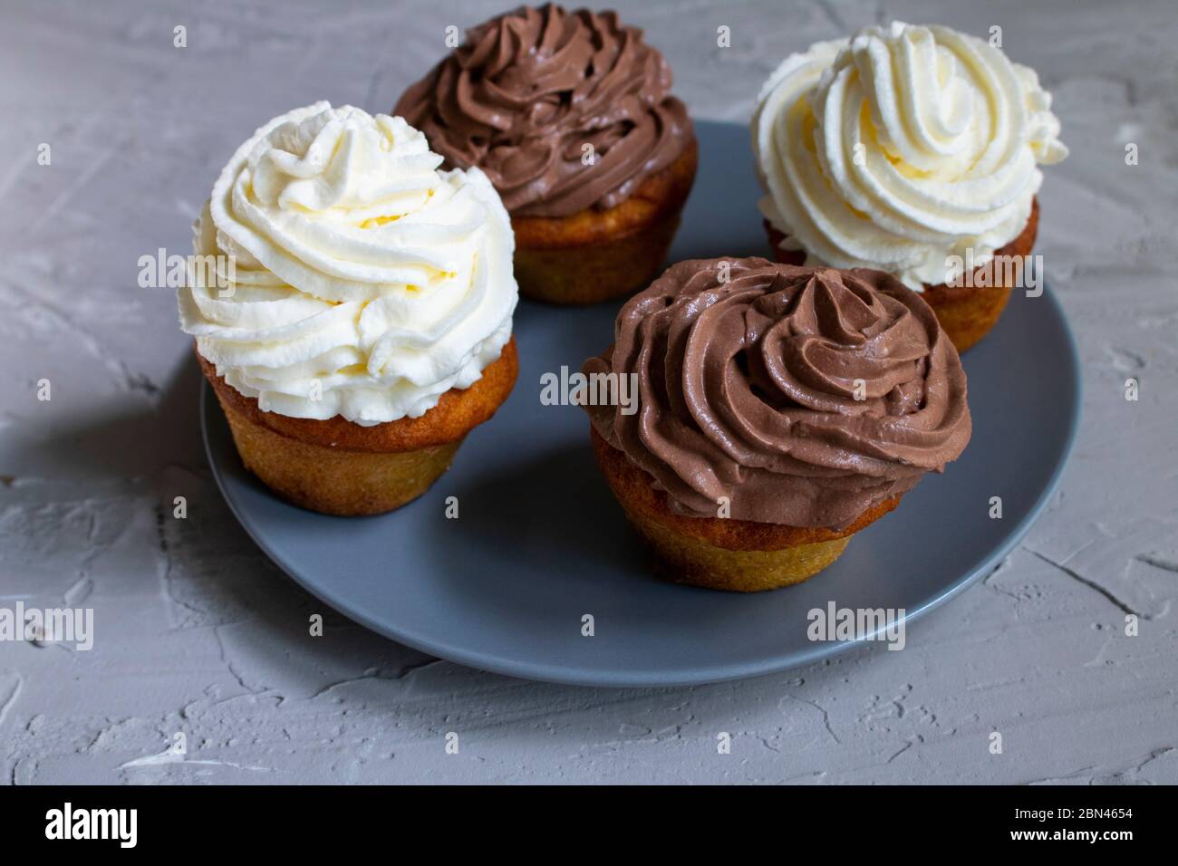 Homemade four cupcakes with caramel syrup and chocolate cream, no gluten meal Stock Photo