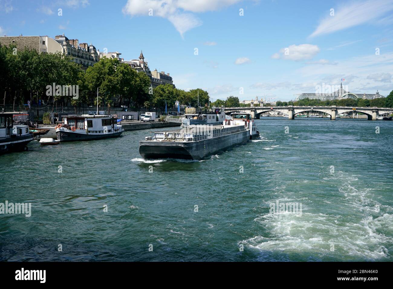 A barge in River Seine with Pont de la Concorde and top of Grand Palais in the background.Paris.France Stock Photo
