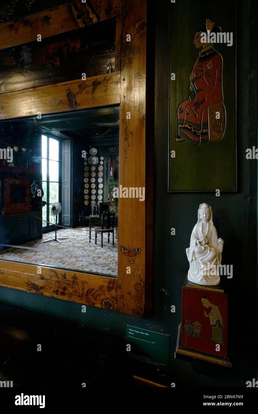 Chinese ceramic statue and wood carving decorated Chinese Lounge in Maison de Victor Hugo (Home of Victor Hugo) Stock Photo