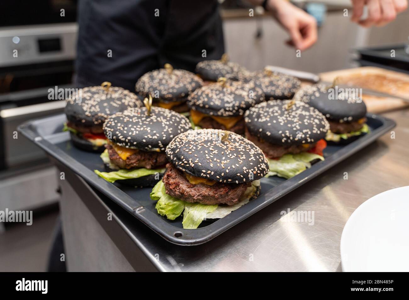 Tray of freshly cooked burgers in a restaurant kitchen Stock Photo Alamy
