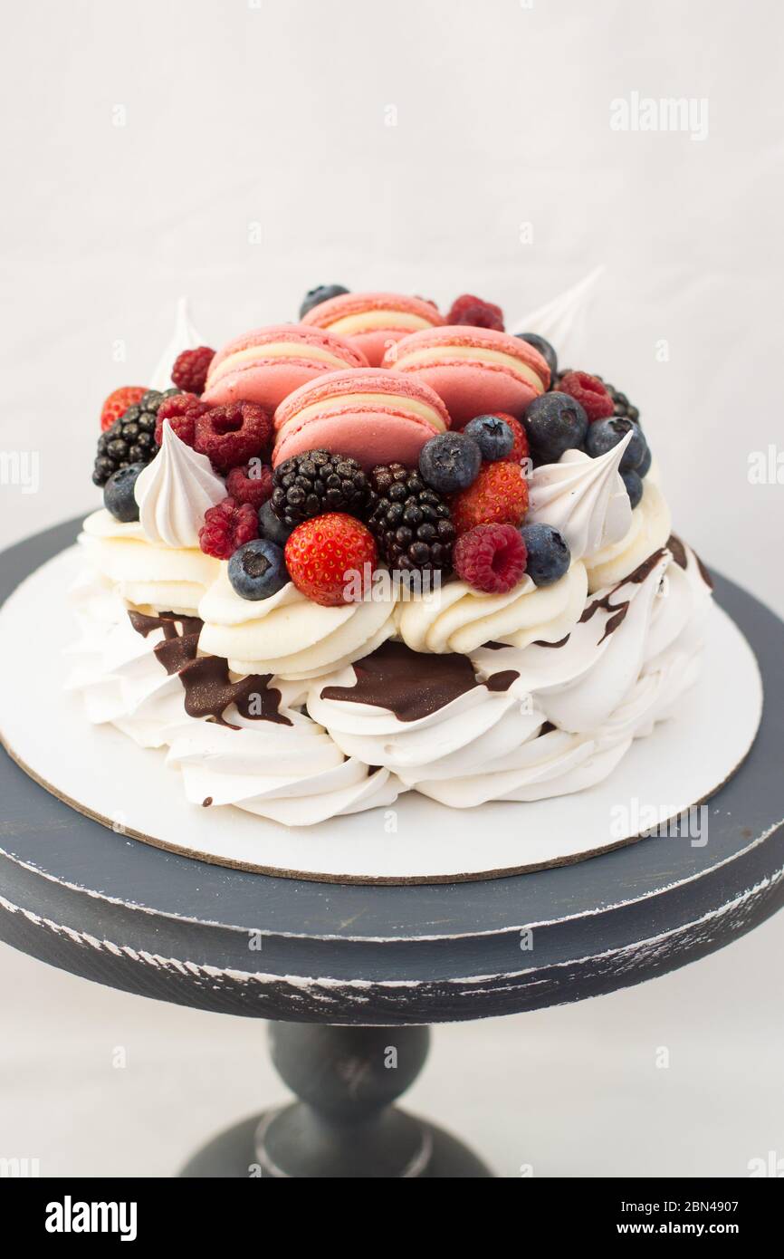 Pavlova cake with whipped cream, raspberry, blueberry, blackberry and