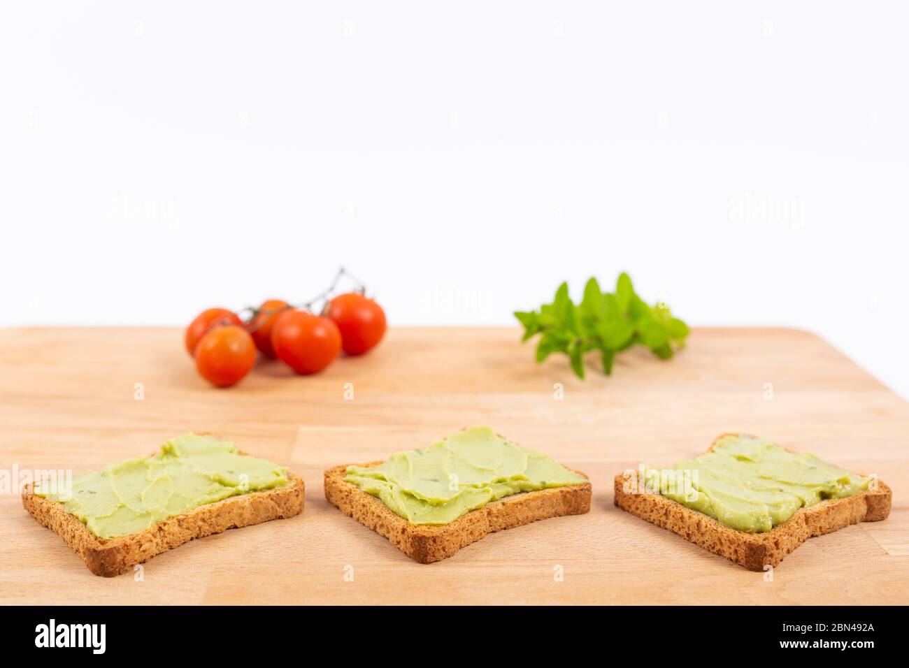 Toast with avocados and cherry tomatoes. Healthy nutrition Stock Photo