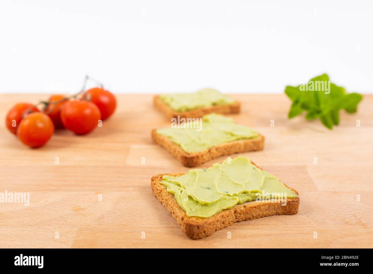 Toast with avocados and cherry tomatoes. Healthy nutrition Stock Photo
