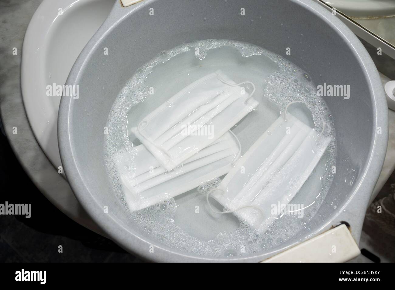 Wahsing face mask in big bowl Stock Photo