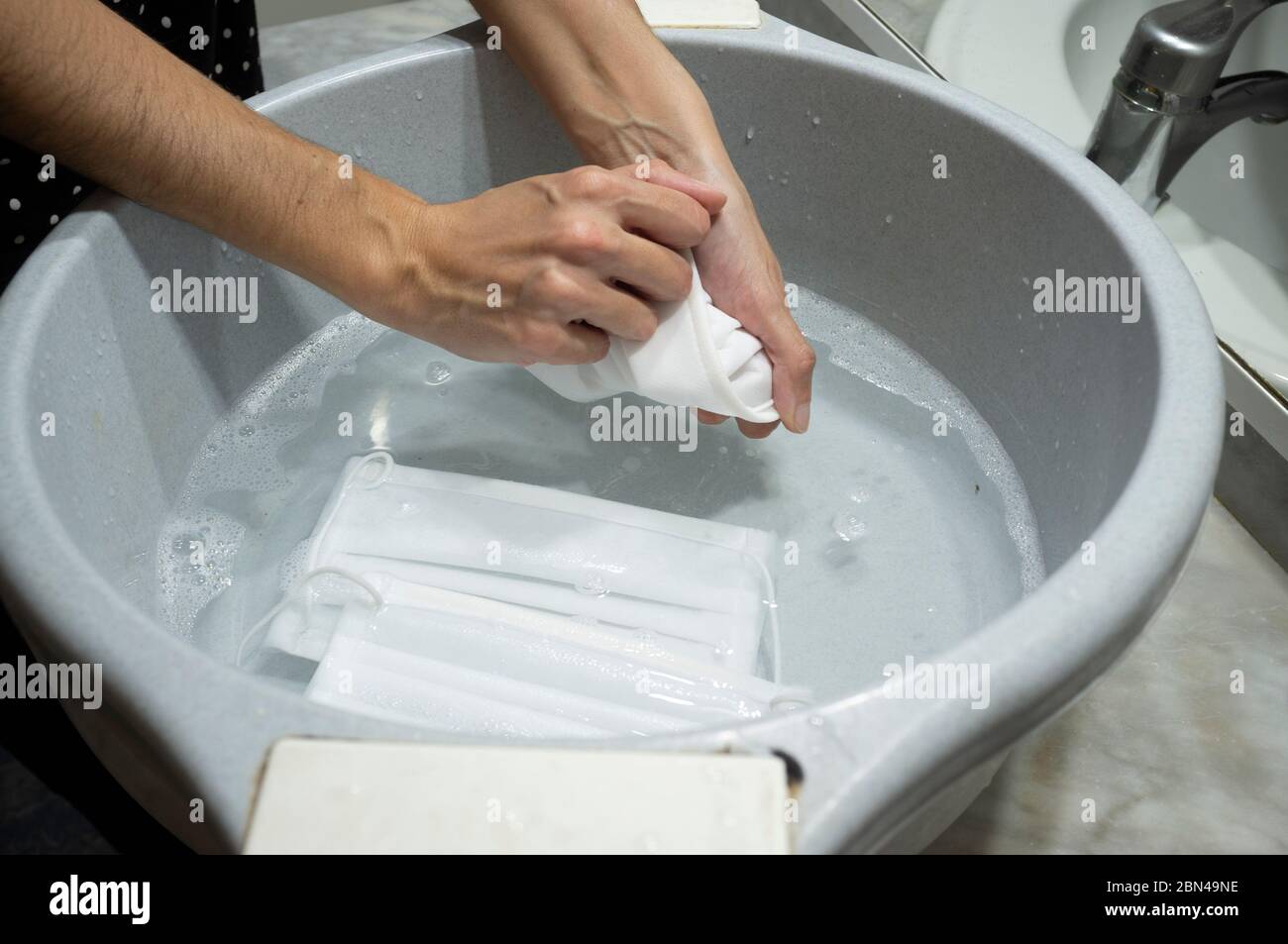 Wahsing face mask in big bowl Stock Photo