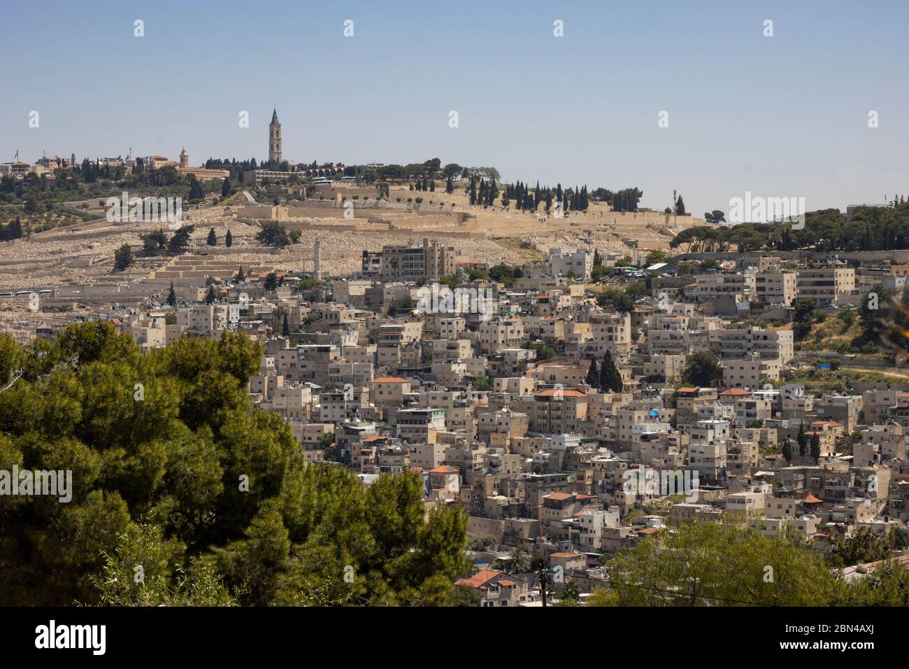 Jerusalem, Israel - May 5th, 2020: Silwan village and Mount of Olives towering above it. Among the sites seen: the russian church of the ascention, Pa Stock Photo
