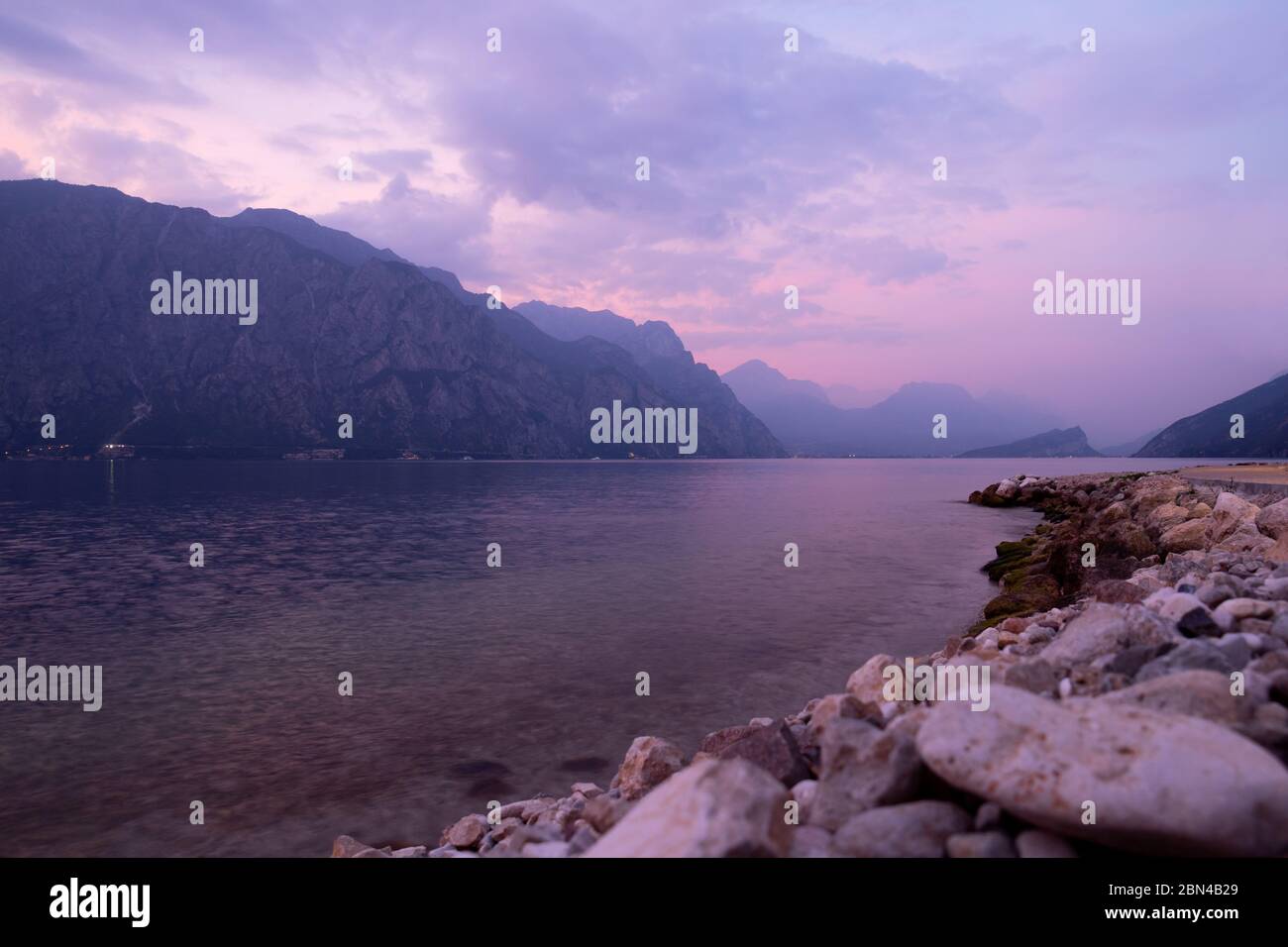 Majestic light just after the sunset - stony beach of lake Garda, northern Italy Stock Photo