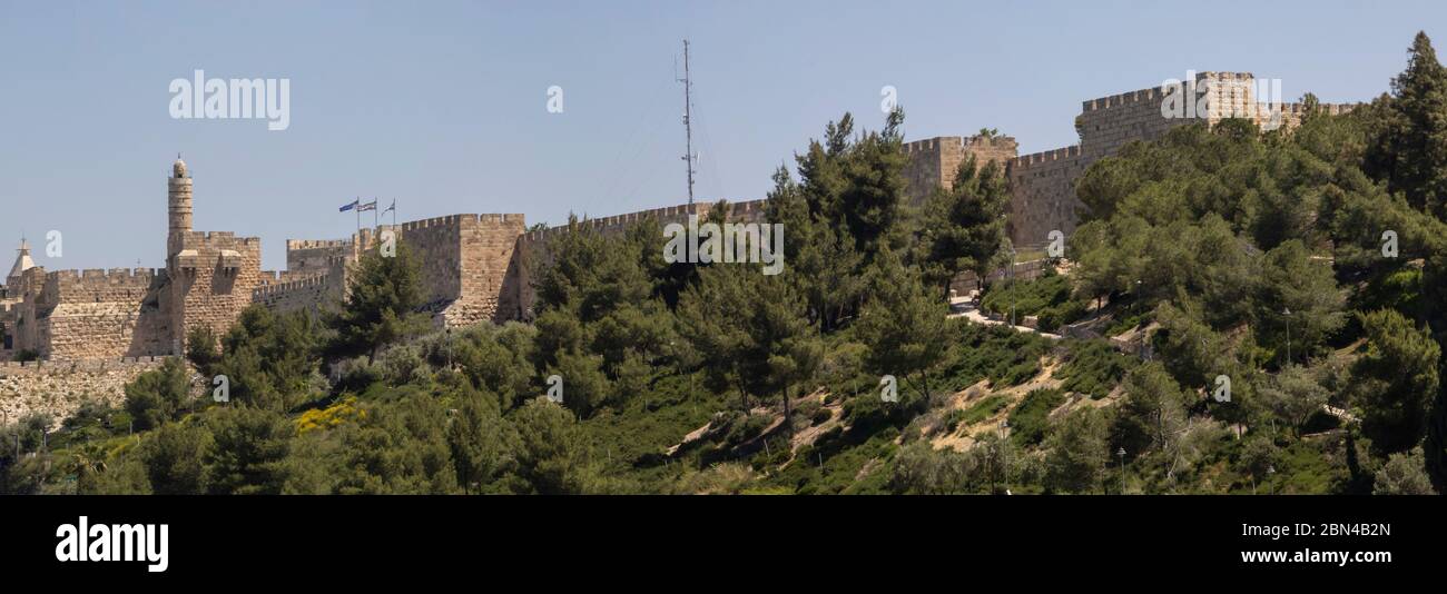 Jerusalem, Israel - May 5th, 2020: The old city of Jerusalem's walls with the tower of David. A panoramic view from south - west. Stock Photo