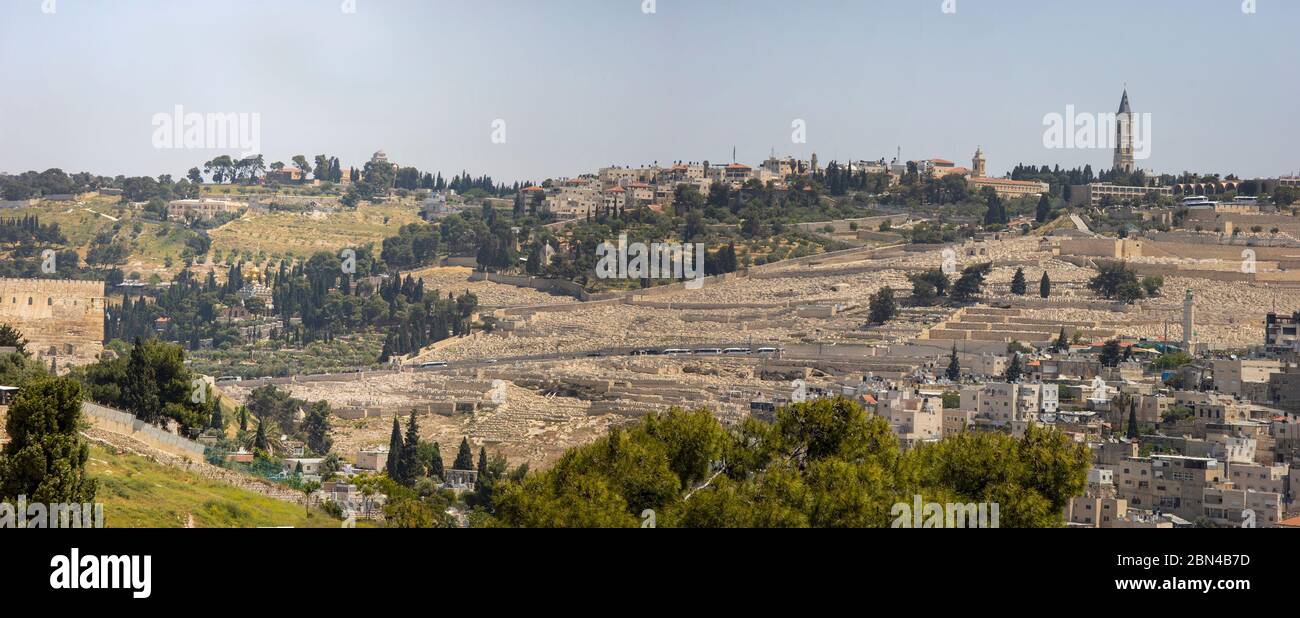 Jerusalem, Israel - May 5th, 2020: Silwan villge and Mount of Olives towering above it. Among the sites seen: the russian church of the ascention, the Stock Photo