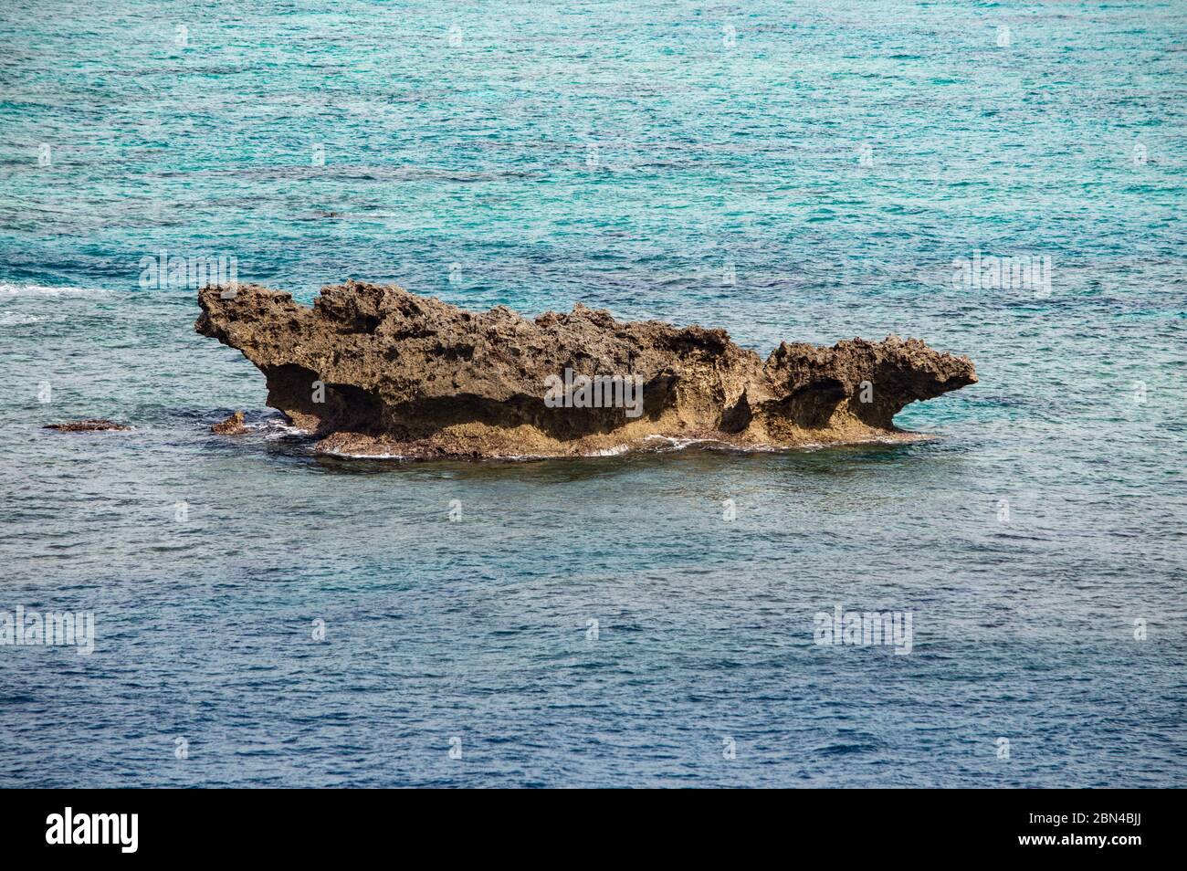 Blue sea and volcanic rock formations on the coast of Okinawa island in ...