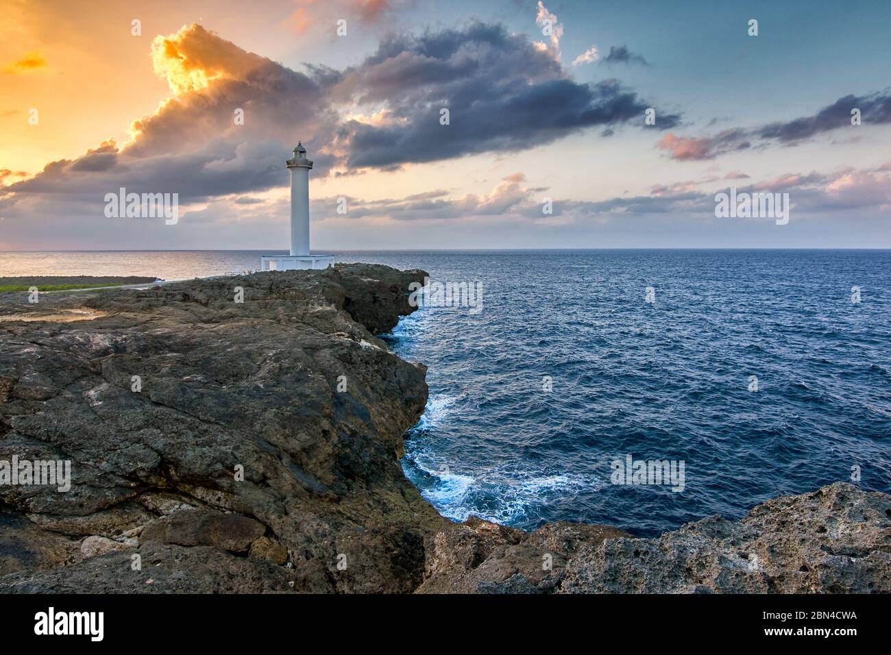 Beautiful sunset at Cape Zanpa with Zanpa Lighthouse on the cliff above ocean, Okinawa island in Japan Stock Photo