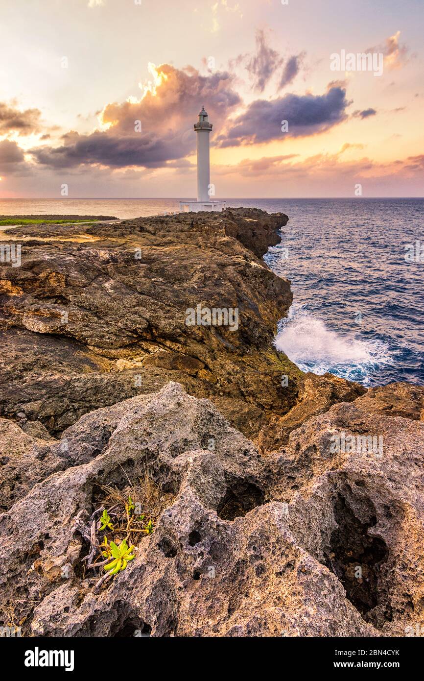 Beautiful sunset at Cape Zanpa with Zanpa Lighthouse on the cliff above ocean, Okinawa island in Japan Stock Photo