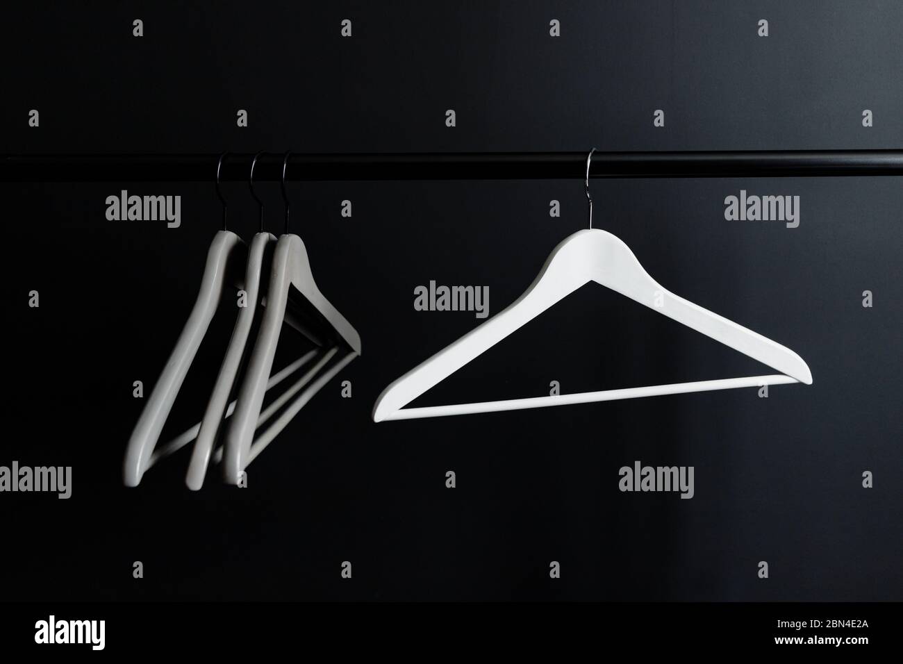 Hangers Without Clothes On A Crossbar Against Black Wall Stock Photo Alamy Hangers Without Clothes On A Crossbar Against Black Wall Stock Photo Alamy