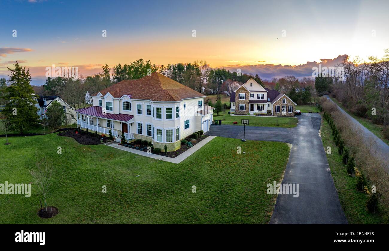 Aerial sunset view of custom designed large single family homes with covered porch in East Coast USA Stock Photo