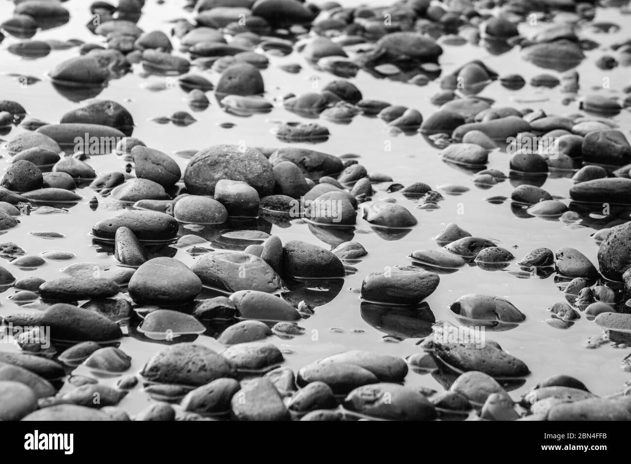 Gray pebbles stones on the shore close up view from above Stock Photo