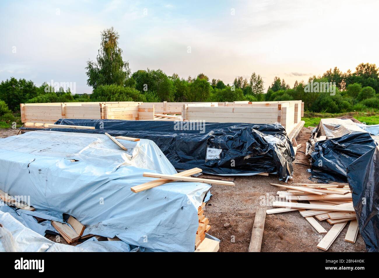 Construction of a new wooden house on the stone foundation Stock Photo