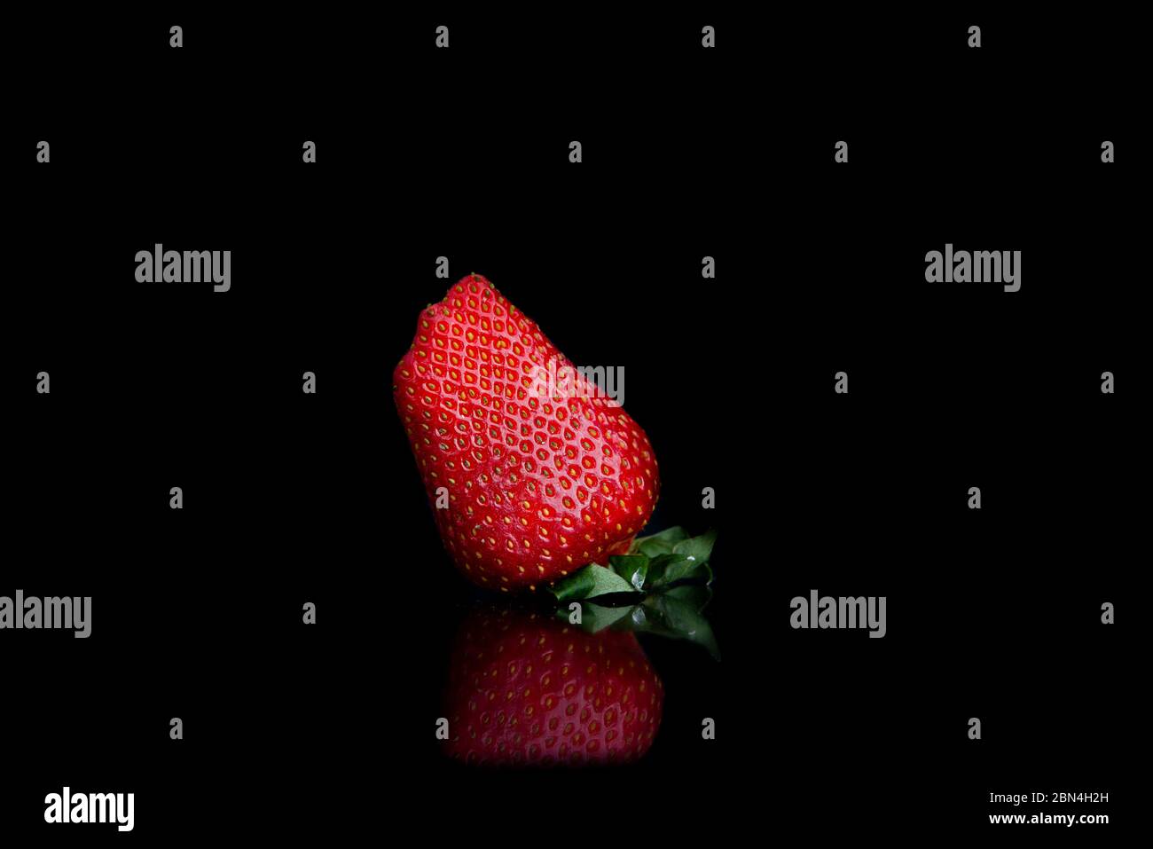 Giant fresh strawberries on a black background with copy space Stock Photo