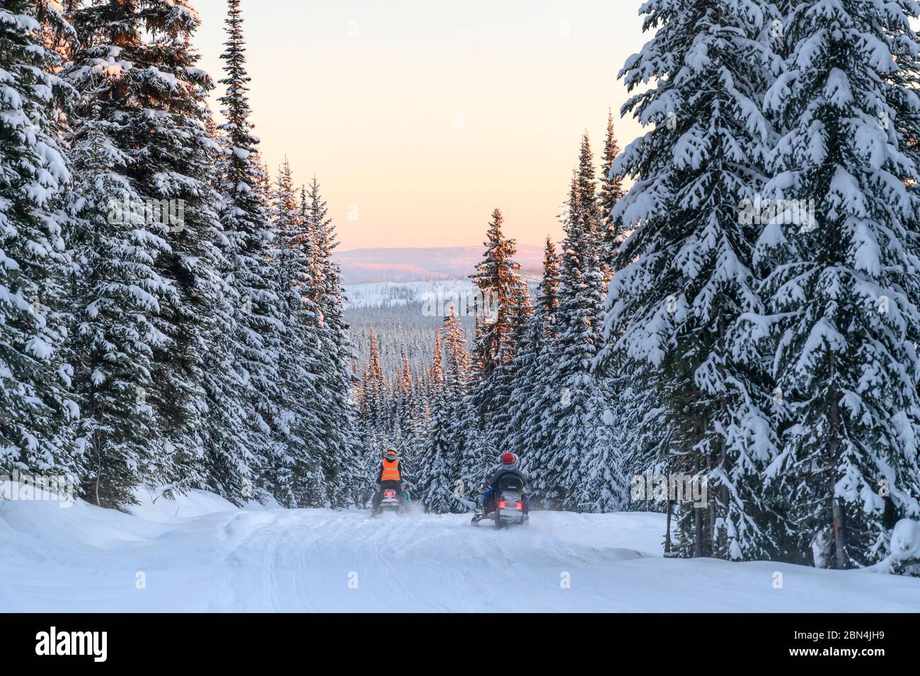 Tourists riding snowmobiles in snow, Sun Peaks Resort, Sun Peaks, British Columbia, Canada Stock Photo