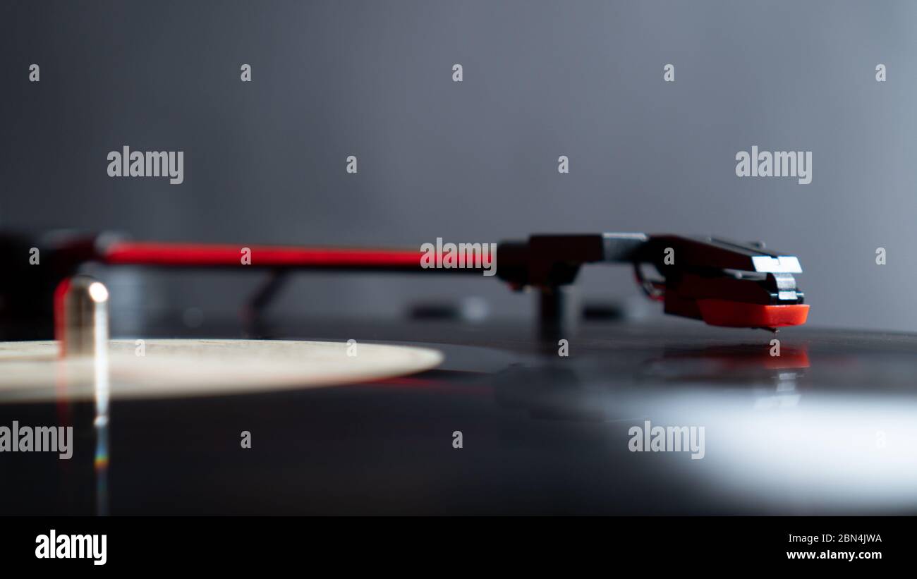 Close up vinyl needle stylus on rotating black vinyl plate or disk with copy space. Turntable vinyl record player. Stock Photo