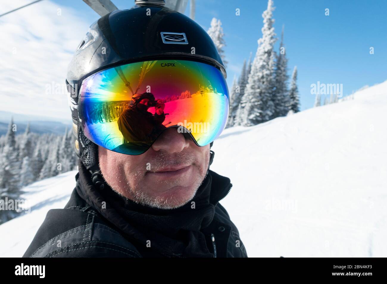 Close-up of a man wearing goggles and a helmet, Sun Peaks Resort, Sun Peaks, British Columbia, Canada Stock Photo