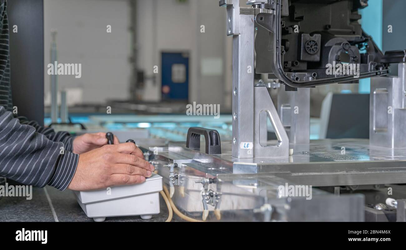 quality engineer controls an instrument for 3D measurement of plastic