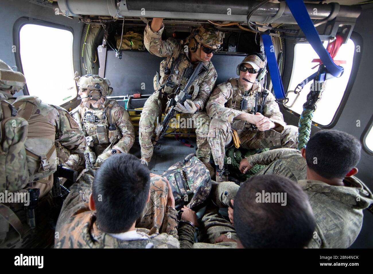 Tucson Sector Border Patrol agents flying on Board a CBP Air and Marine Blackhawk helicopter, located and apprehended a group of illegal aliens near Pisinemo, Arizona on the Tohono Oʼodham Indian Reservation on May 22, 2019. The aliens wore camouflage in hopes of avoiding detection. U.S. Customs and Border Protection Stock Photo