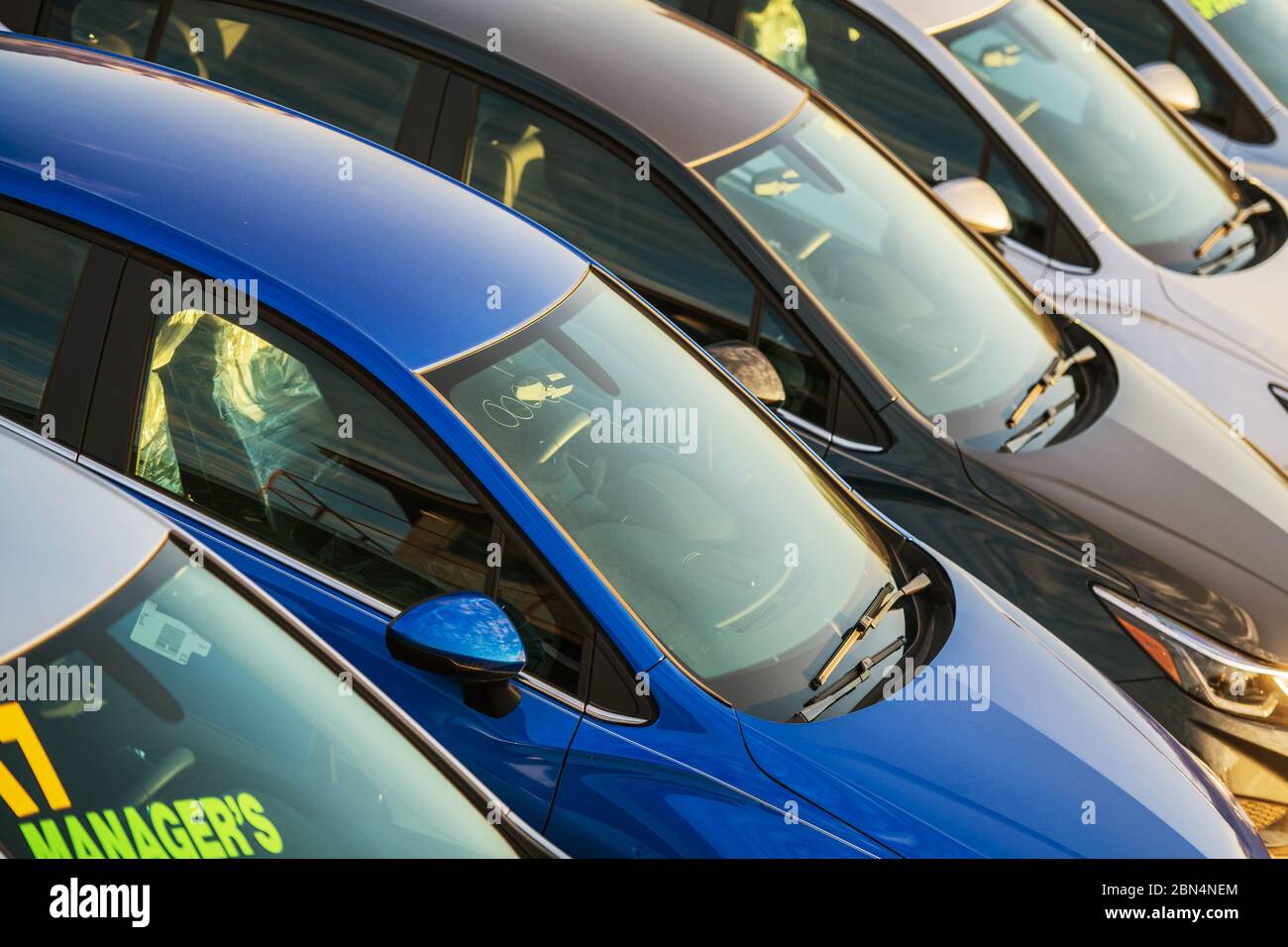 Close Up Of Multiple New And Used Vehicles For Sale At Car Dealership Lot. Stock Photo