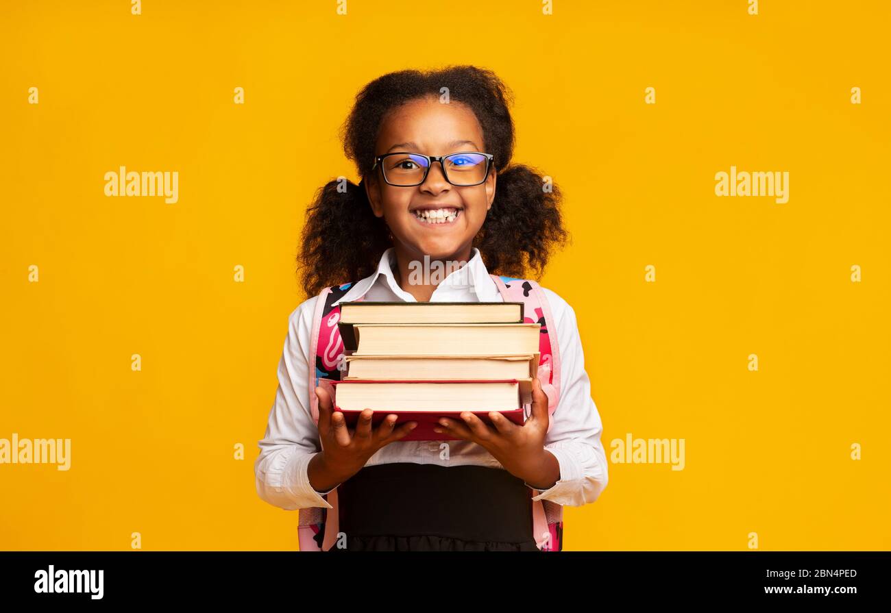 Elementary School Girl Holding Books Posing, Studio Shot Stock Photo ...